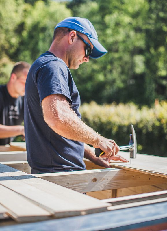 Das Dach des Gartenhauses wird mit einzelnen Brettern gedeckt.